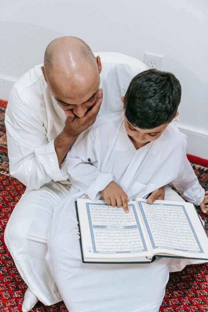 Father and son bonding while reading the Quran together